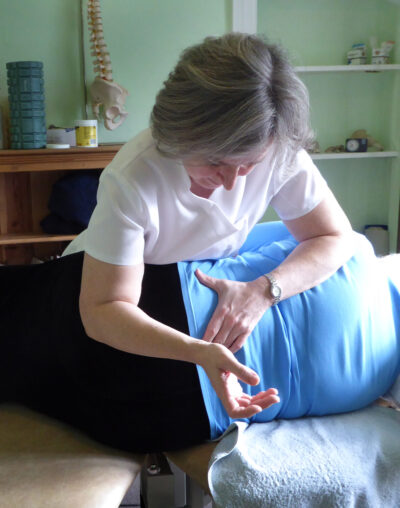 Osteopath manipulating a patient's lower back